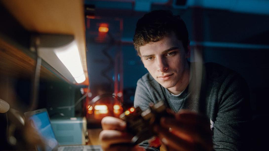 A Kettering electrical engineering student studies a circuit in the Design Circuit Lab